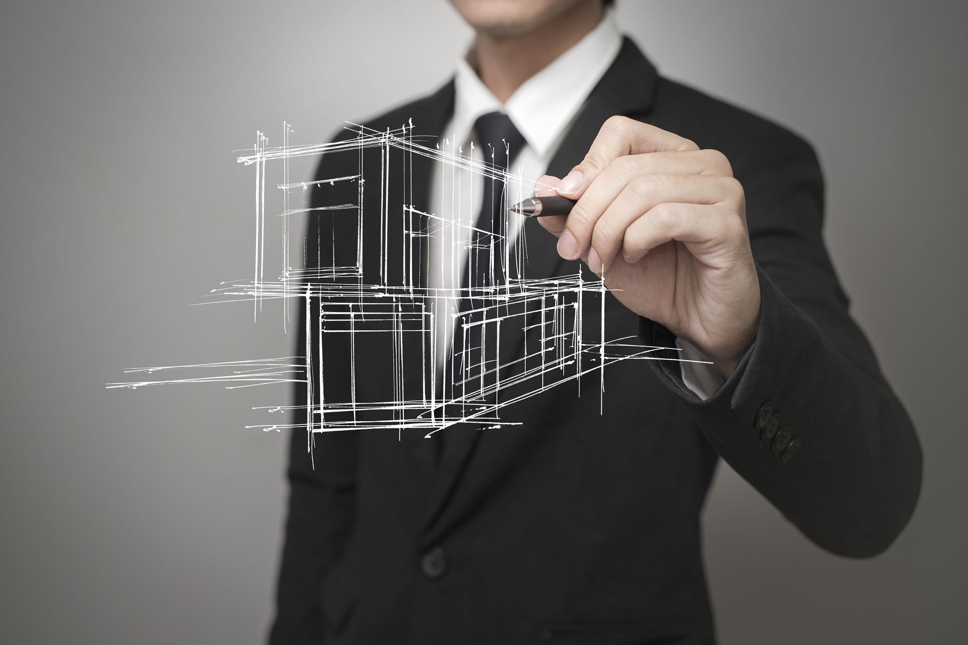 Businessman drawing a model of the house